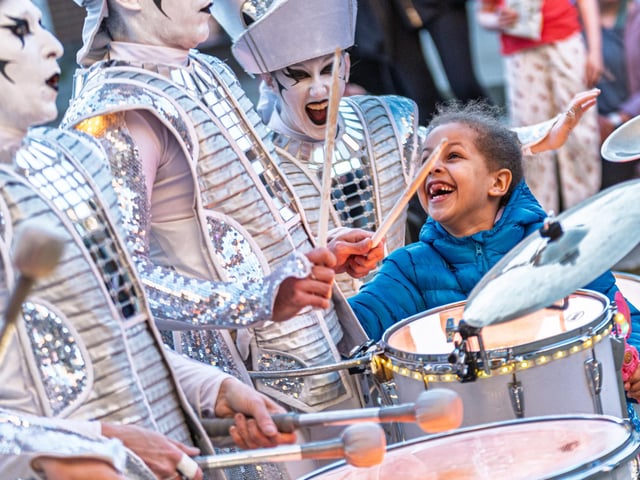 A young audience member with the Spark! Drummers