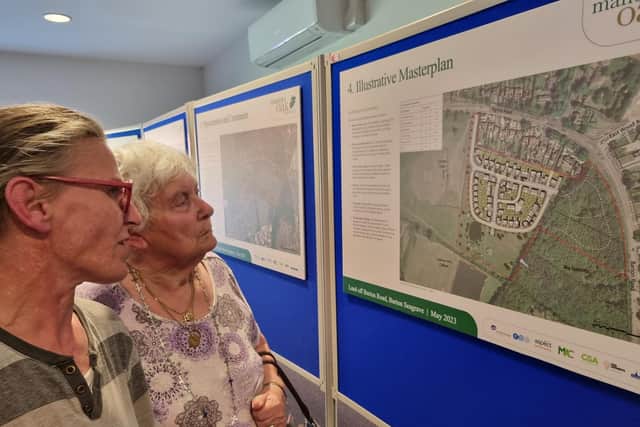 Residents examine the plans