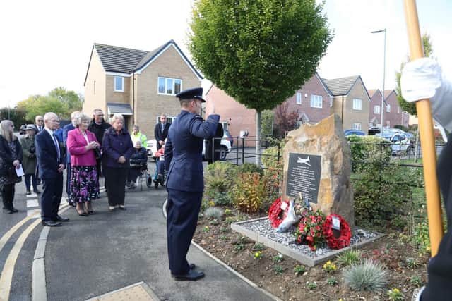 Squadron Leader Luke Ridgway salutes to honour the fallen airmen of RAF Desborough