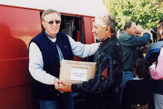 Derek handing over a family food parcel