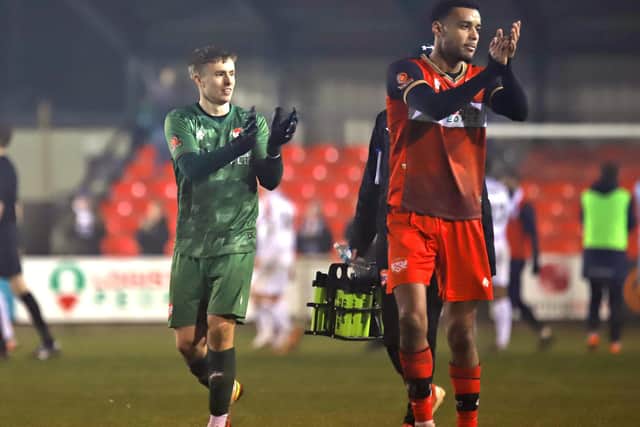 Goalkeeper Harrison Foulkes and striker Tyrone Lewthwaite applaud the Kettering fans after the draw with AFC Fylde