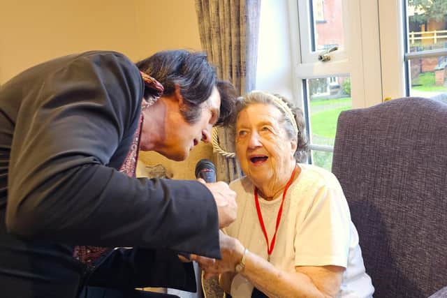 Resident Mabel from Elm Bank care home caught up in the magical moment with Peter the Elvis tribute act