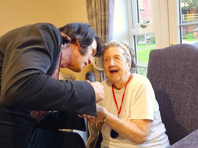 Resident Mabel from Elm Bank care home caught up in the magical moment with Peter the Elvis tribute act