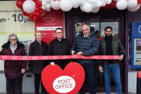 Peter Bone cuts the ribbon to the Post Office