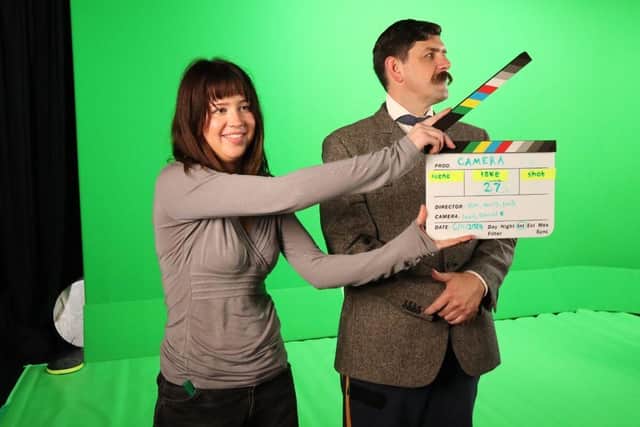 Student marks the final take with clapperboard.