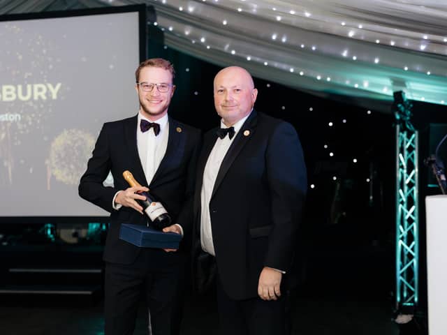 Dom is pictured receiving his award from Group Regional Operations Manager Mark Chapman.