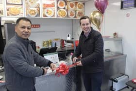 Tom Pursglove (right) cutting the ribbon at Wokswagon with owner, Mr Chen (left)