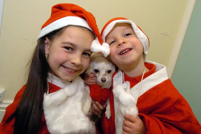 Lucia Dainty, 8, and pet dog Bubbles and brother Gianluca Dainty, 4, dressed ready for the Santa Saunter at Wicksteed Park in 2010