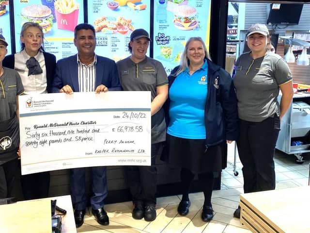 Franchisee Perry Akhtar and Caroline Sinclair from Ronald McDonald House Oxford with crew from one of his restaurants