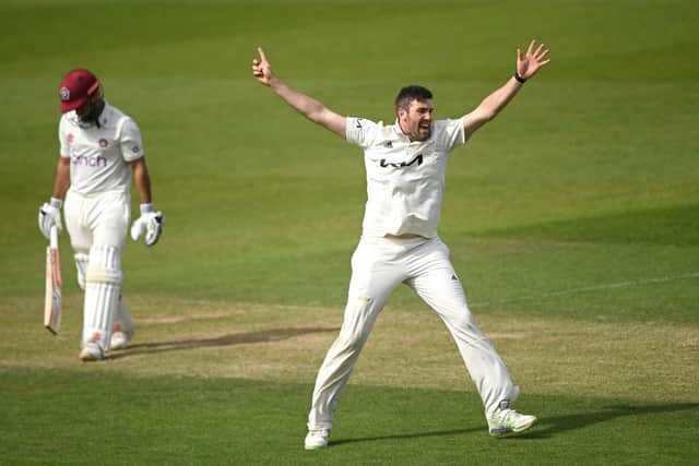 Surrey's Jamie Overton celebrates claiming the wicket of Northants' Saif Zaib