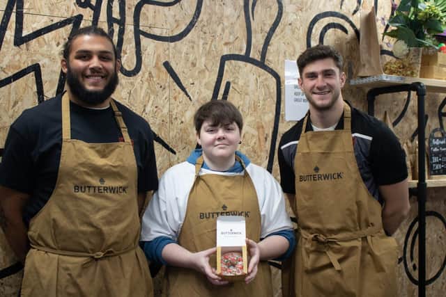 Callum, who designed the doughnut, is pictured with Saints stars and foundation ambassadors, Lewis Ludlam and James Grayson