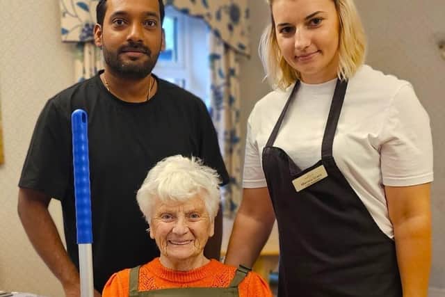 Christine proudly seated after been given the position of Resident Head Housekeeper