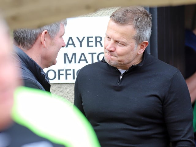 Former Poppies boss Mark Cooper talks things over with current manager Lee Glover