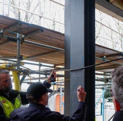 Signing the steel frame at Maggie's Northampton