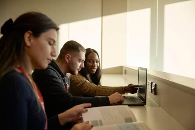 People looking at a laptop