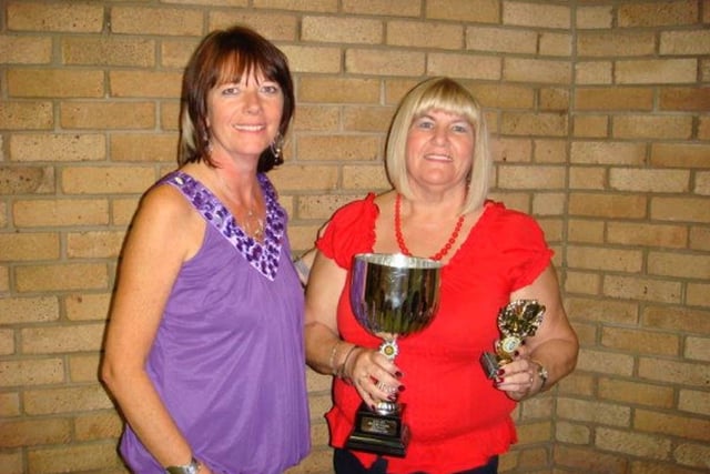 Audrey Neale (secretary, left) presents the Kettering & District Ladies Darts League individual winner's prize for 2009 to Sylvia Jones:Darts retro special
