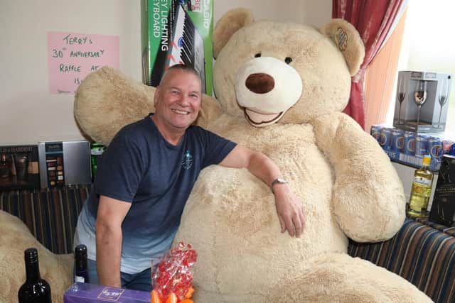 Terry Gunn with the giant teddy bear that will be auctioned for Cransley Hospice