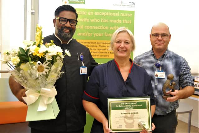 Midwife Rhonda Hales (centre) is presented with her award by Prof Ganesh Baliah (L) and Interim Director of Nursing Robin Binks (R).
