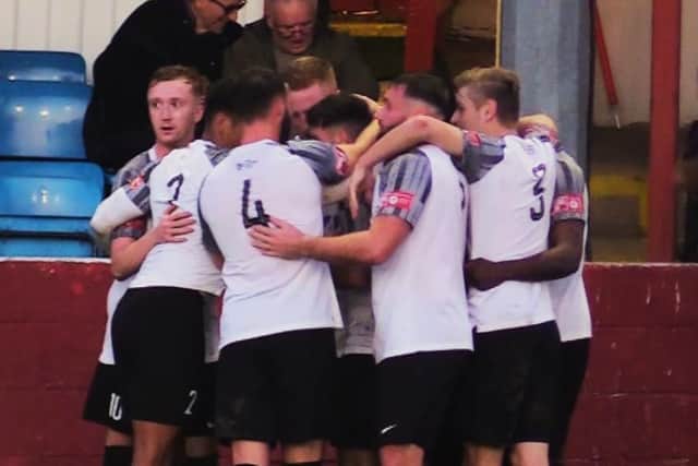 The Corby Town players celebrate one of their goals in the 3-0 win at Gresley Rovers. Picture by David Tilley