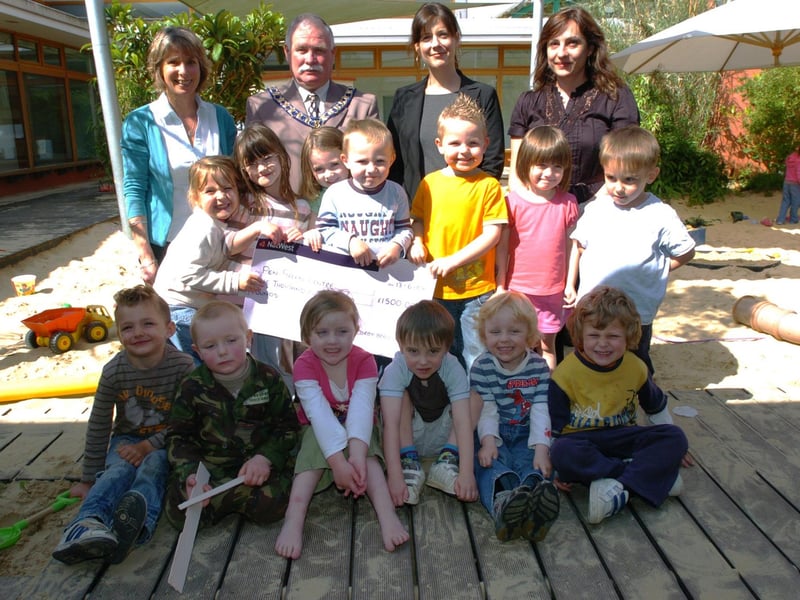 Staff and children from the nursery received a cheque from Corby mayor Cllr Peter McEwan in 2008.