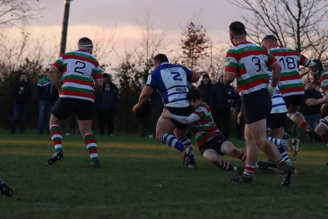 A Kettering player is tackled by a Lutterworth opponent. Picture by George Halfhide