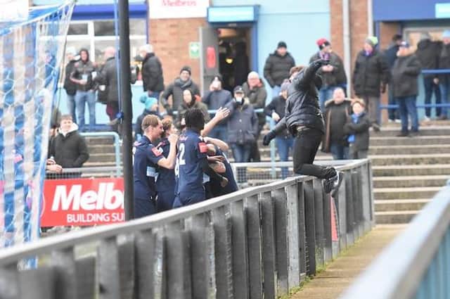 The Diamonds players, and a supporter, enjoy Cairo Taylor's opening goal at Rugby Town (Picture: Shaun Frankham)
