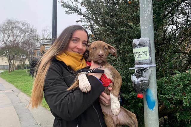 Amy Kelsey, pictured with her four-month-old American bulldog Paxton, has been leaving bottles with poo bags on lamp-posts encouraging pet owners to clear up after their dog.