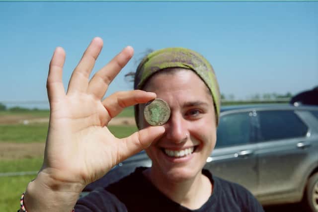 Yerai from Oxford Archaeology with a Roman coin discovered at the Priors Hall site