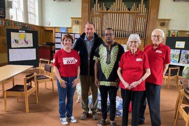 Mr Hollobone, MP of Kettering, visiting the exhibition with members of the Kettering Christian Aid Group, and Rev Noel Nhariswa, minister of Central Methodist Church
