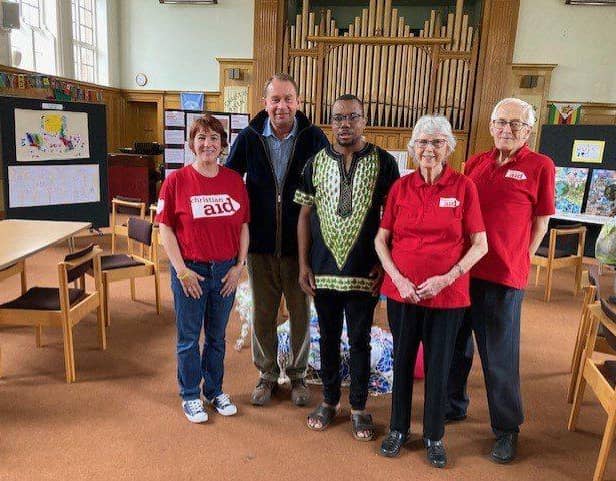 Mr Hollobone, MP of Kettering, visiting the exhibition with members of the Kettering Christian Aid Group, and Rev Noel Nhariswa, minister of Central Methodist Church