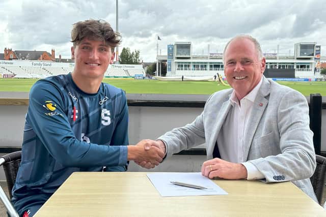 Raphy Weatherall shakes hands with Northants chief executive Ray Payne after signing his new deal