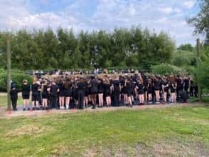 Children deliver an outdoor performance.