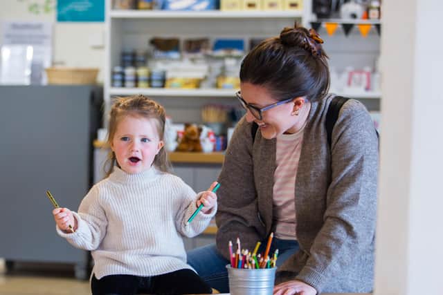 Young families enjoying craft activities in the visitor centre at Stowe House