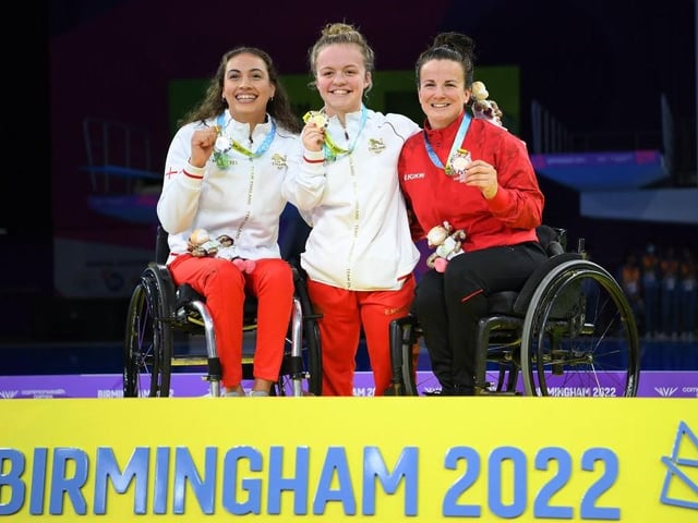 Silver medalist Grace Harvey (left) and bronze medalist Camille Berube (right) flank Maisie Summers-Newton
