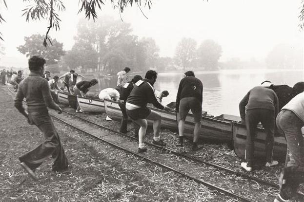 Wicksteed Park people taking part in a rowing boat race on the lake