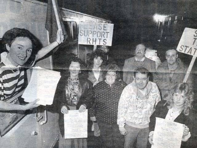 Frances Mackness holds up a petition calling for Rushden Train Station to be saved from demolition watched by members of the Save Rushden Rail Station committee in October 1990