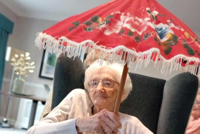 A care home resident sitting comfortably and enjoying the activities.