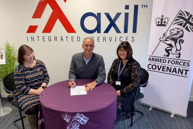 Kathy Warfield, ex-RAF, and Kirstie Parker, Deputy Employer Engagement Director at the Ministry of Defence, witness Ed Pigg signing the Armed Forces Covenant.