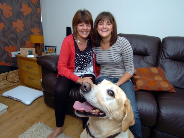 Kettering family helped by Red Cross when their house burned down a week before Christmas 2008. Mum Karen Hull with daughter Sarah Hull and dog Watson who rescued Sarah from the house. September 2010