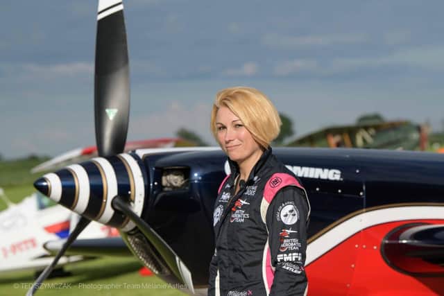 Mélanie Astles with her Extra 330 aircraft