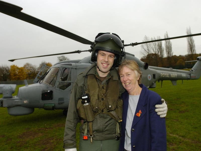 A Royal Navy helicopter lands on the school field in November 2006. Pilot James Harriott, with his mum Bethan Forbes.