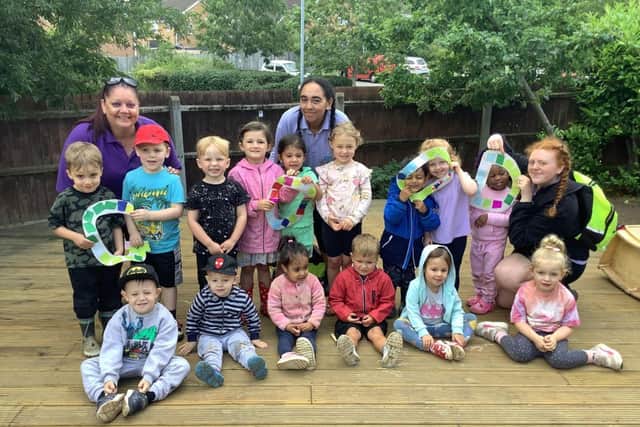Staff and children at Kiddi Caru Day Nursery in Wellingborough celebrating their good rating from Ofsted