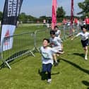 A team crossing the finish line of the Oundle Schools Triathlon.