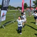 A team crossing the finish line of the Oundle Schools Triathlon.