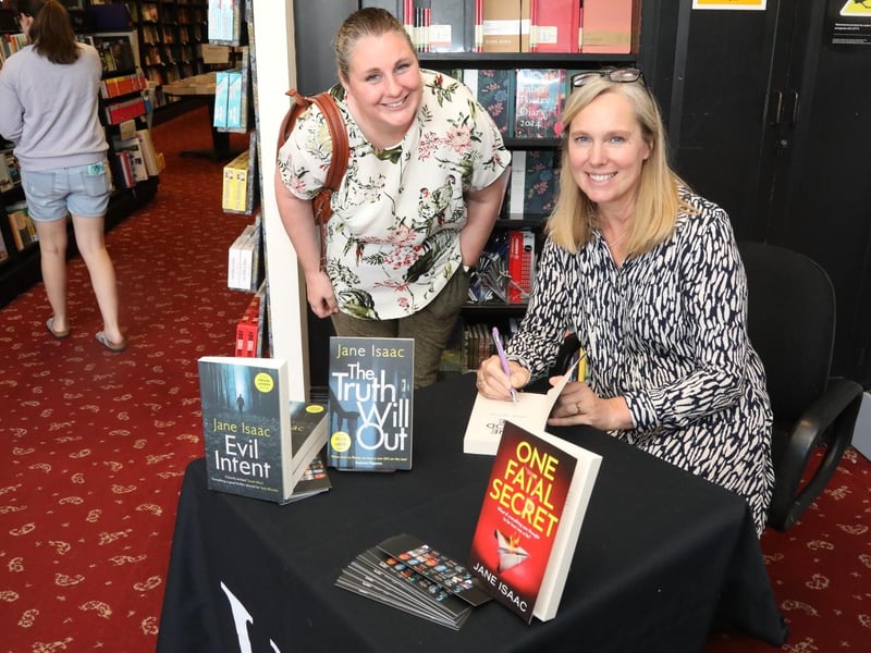 Kettering Festival of Literature 2023 - Loddington author Jane Isaac signs one of her novels for Rachel Hull.