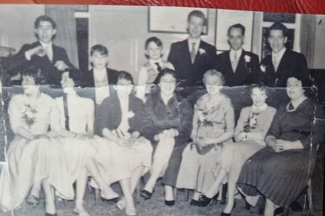 The Chapman family - June on her wedding day in 1958 celebrates with her 10 siblings in the White Hart  - June in the centre with the black shoes