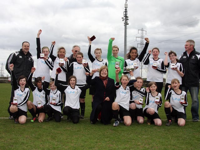 Victorious Kingthorpe captain and team hold the cup high with Sally Keeble MP