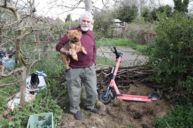 David Gater and dog Teddy with the Voi scooter that landed in his compost heap