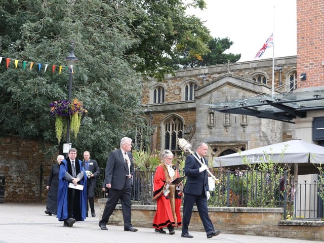 Mayor of Kettering Cllr Keli Watts is lead into the market place by mace-bearer Martin Lewis