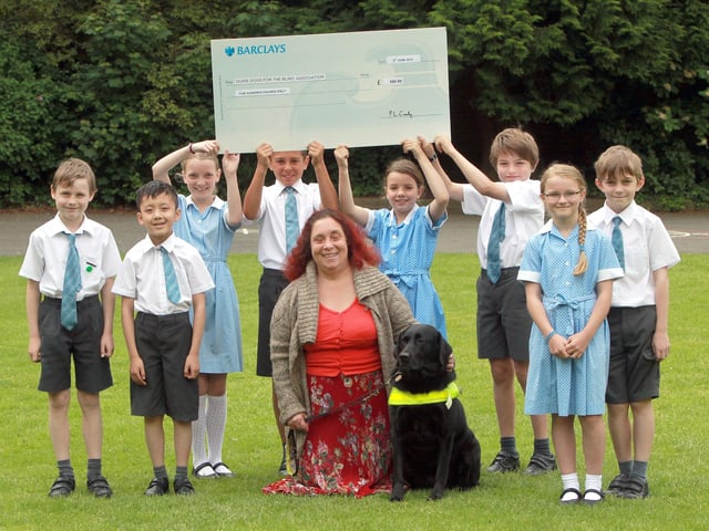 Pupils from St Peter's School, Kettering, have raised £500 for Guides Dogs Celia Martin and her guide dog Eliza